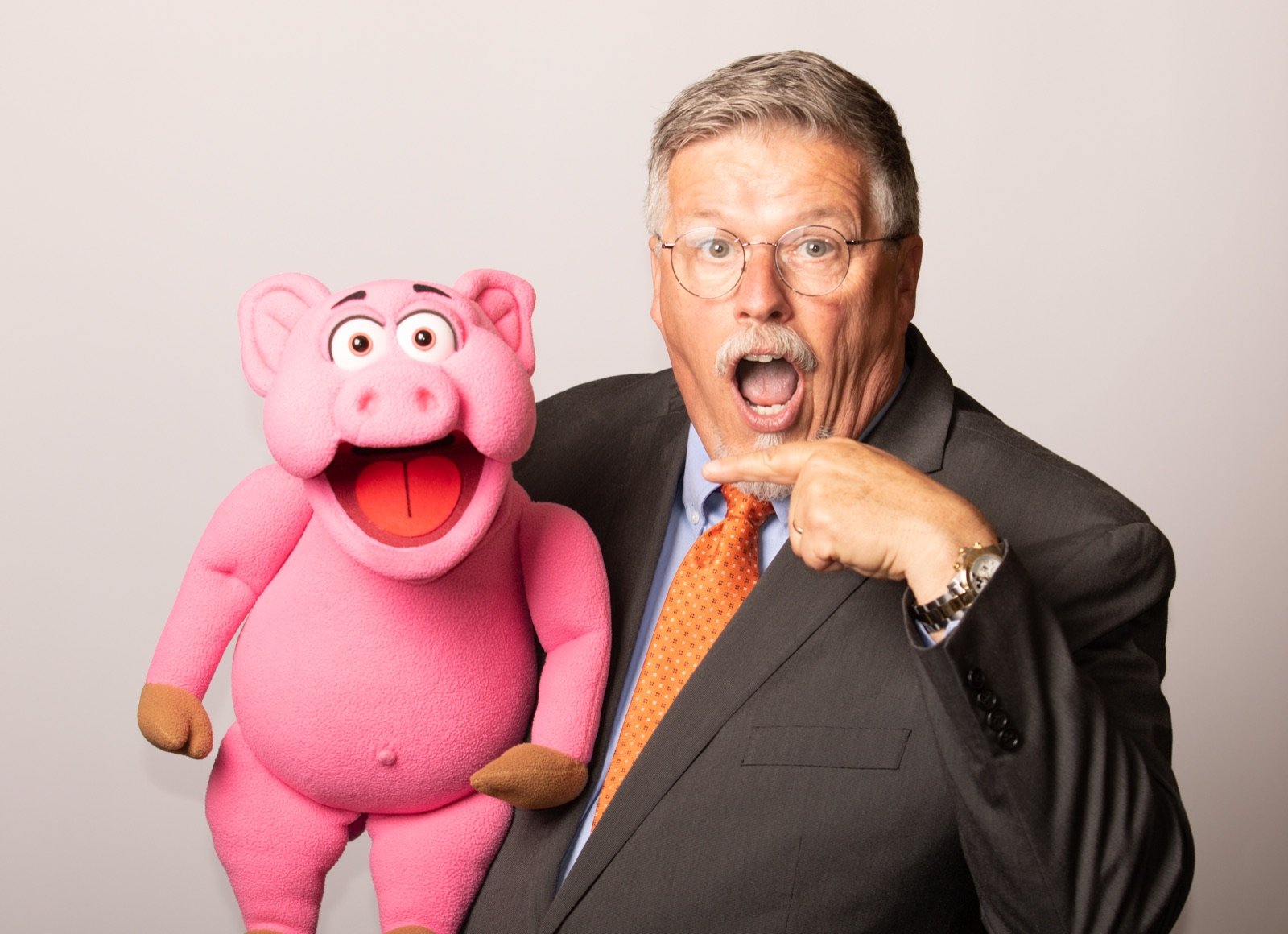 Expressive portrait of a performer with a bright pink character
