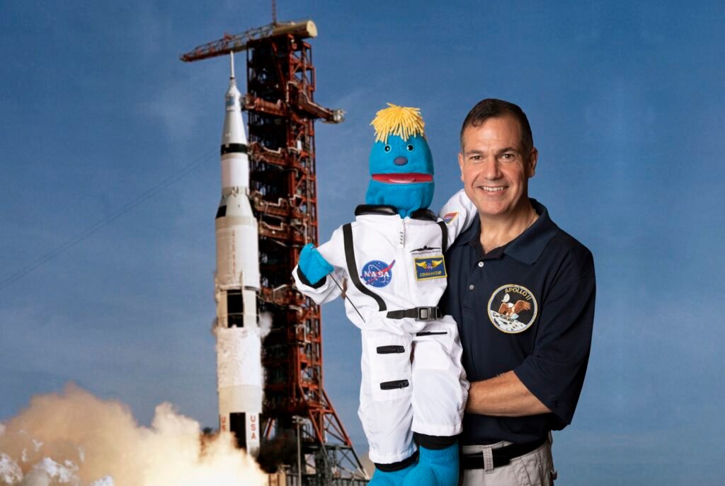 NASA-inspired promotional portrait with a performer and character