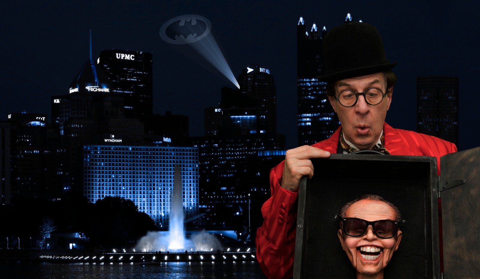 Comedic performer portrait against the Pittsburgh skyline at night
