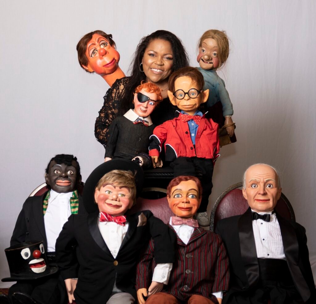 Performer surrounded by a large ensemble of expressive characters